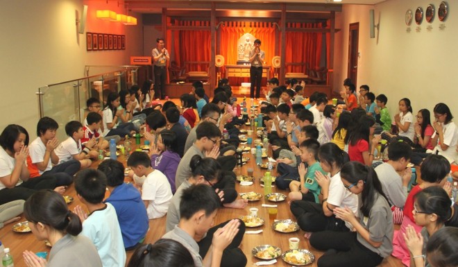 Participants sitting down  for a communal lunch.