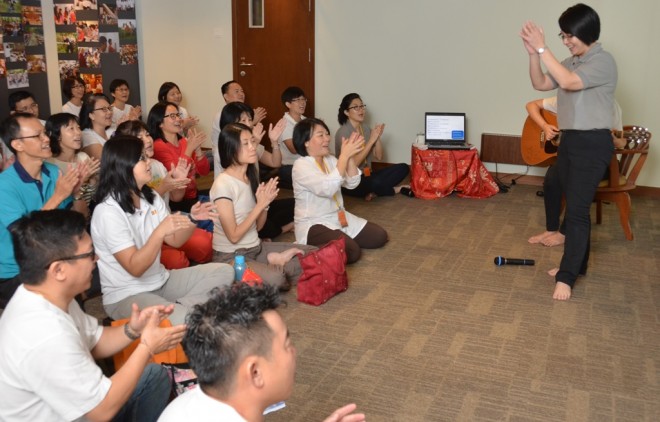 Sis. Nandini leading participants in a sing-along session.