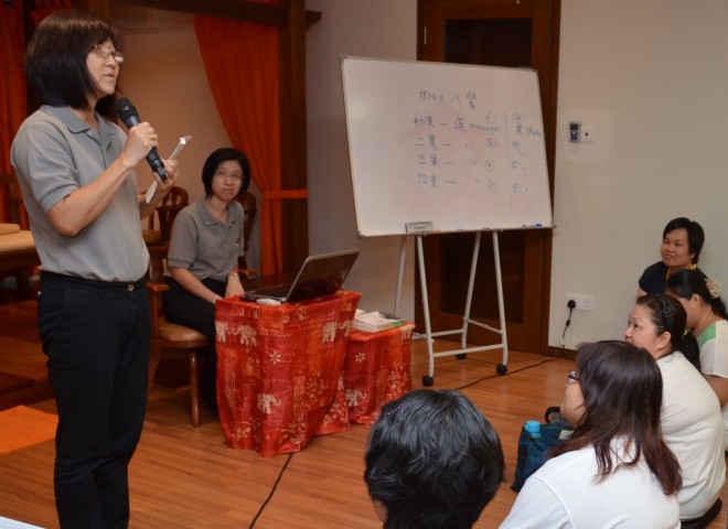 A group representative presents a summary of her group's discussion.