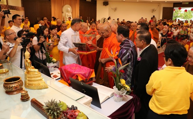 Sangha members and dignitaries viewing and worshiping the relic.