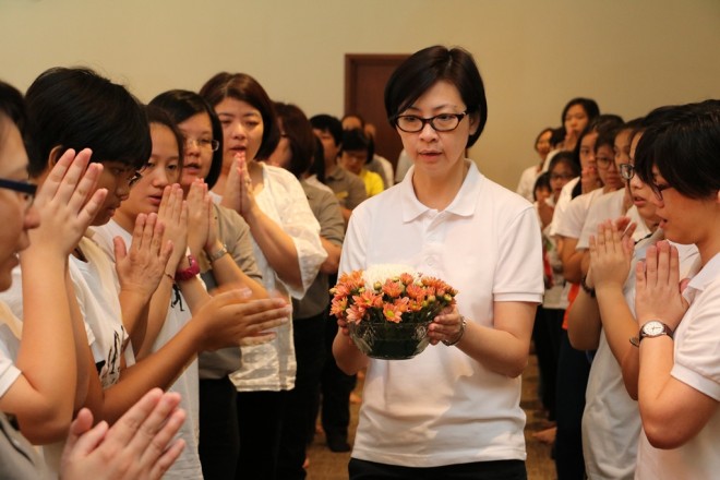 Offering of flowers to the Three Jewels.