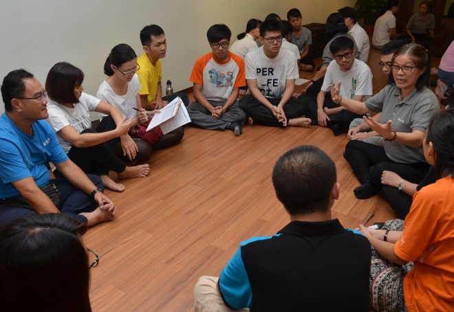 Sis. Siew Kim (in grey t-shirt) briefing her team members.