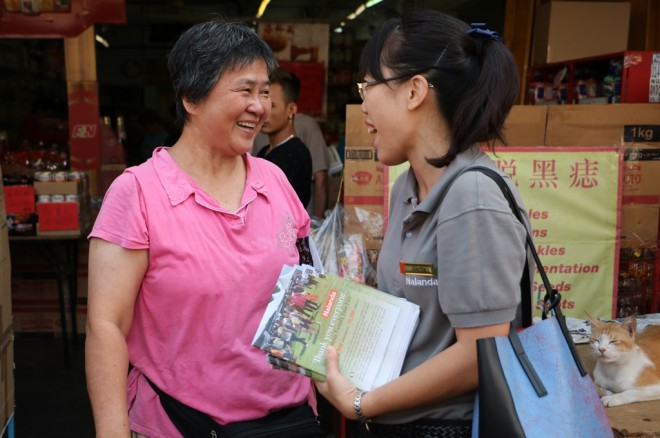 Nalandian volunteer engaging with the public.