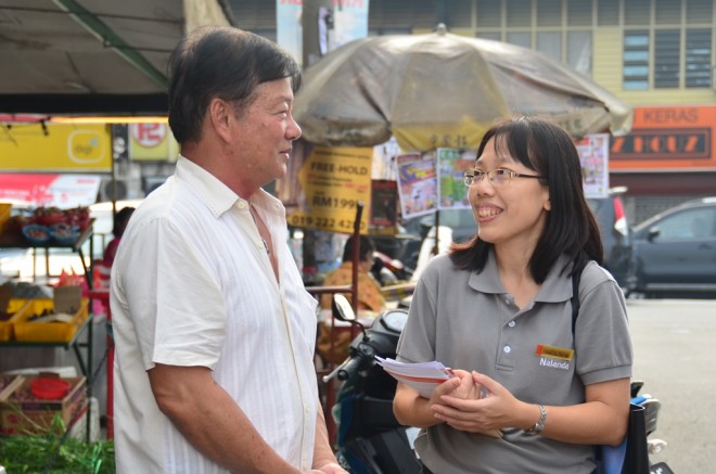 Nalandian volunteers engaging with market-goers.