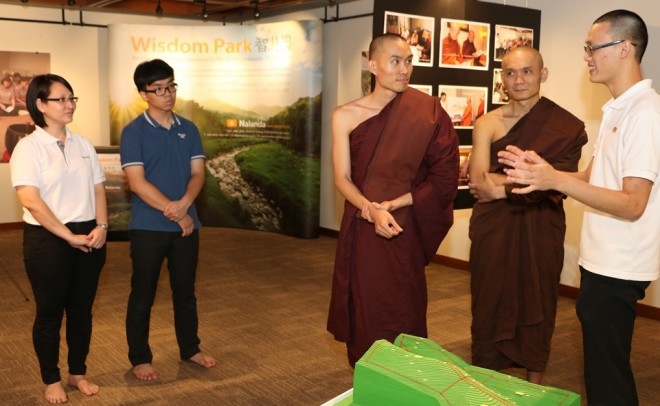 Bro. Ajita (right) explaining the Wisdom Park project to the venerables.