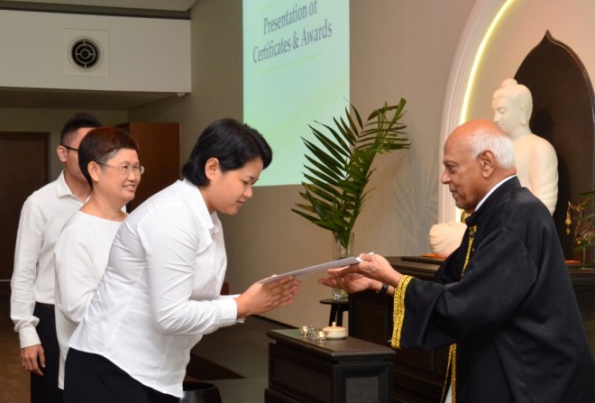 Achariya Vijaya presenting certificates to graduates.