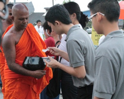 Pindacara (almsround) on Wesak Dawn - Fulfilling our duty as lay devotees by supporting Sangha members.