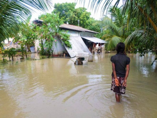 A youth contemplating her future as her house was inundated by the floods.