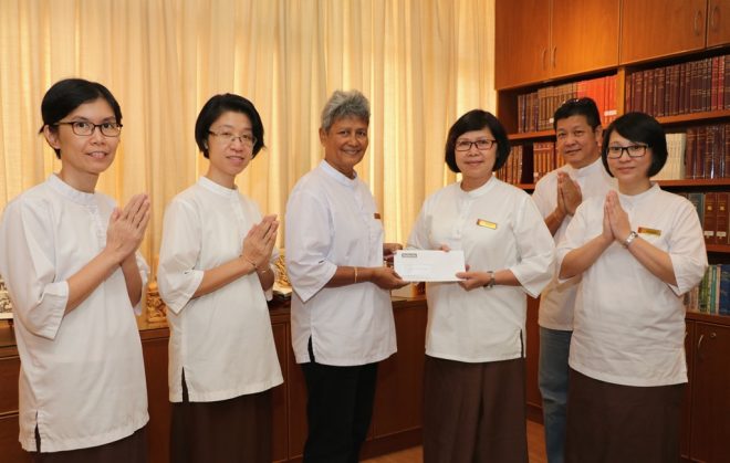 President Sis. Evelyn handing over the “Sri Lanka flood relief fund” to TBCM.